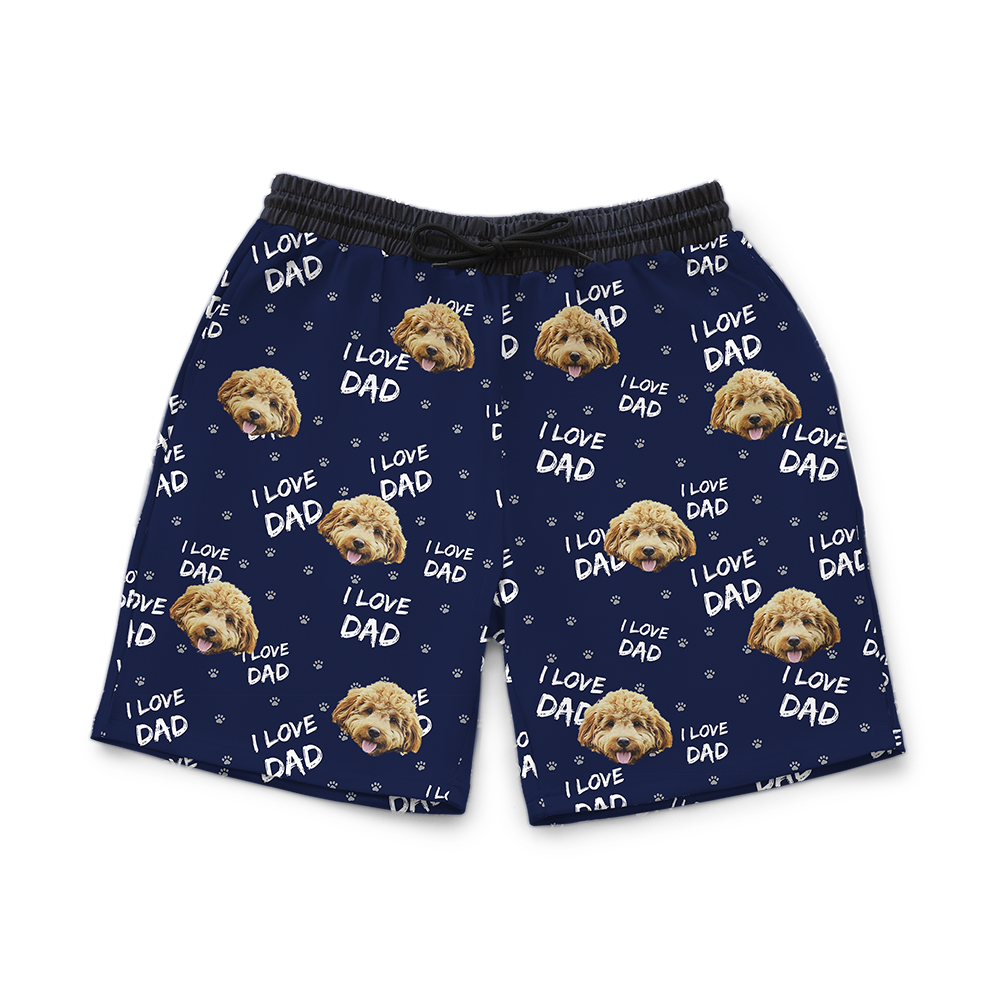 Custom navy blue men’s sweat shorts featuring a repeating pattern of a small fluffy brown dog’s face and the phrase ‘I Love Dad’ with white paw prints scattered throughout.
