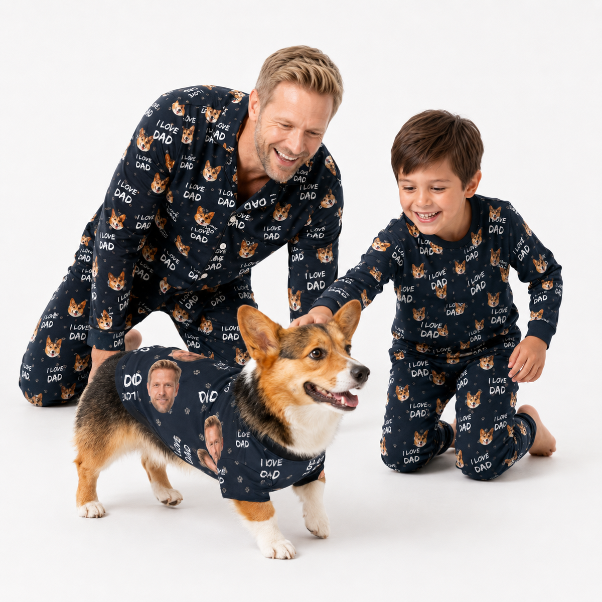 Man, child, and corgi wearing matching black “I Love Dad” custom pet pajamas on a white studio background.