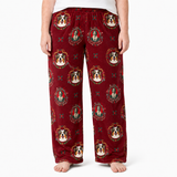 A person wearing fleece lounge pants with a red base and an all-over print of Australian Shepherd dog heads inside ornate circular frames, shown against a plain white studio background.
