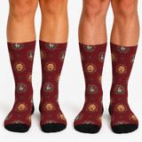 Three pairs of crew socks worn on legs, featuring a dark red background with a repeating pattern of small dog portraits in ornate frames and black toes and heels, against a plain white background.