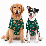 Two dogs wearing matching green holiday-themed dog t-shirts with a festive print, posed against a solid white background.