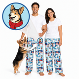 A man and a woman wearing matching white t-shirts and light blue pajama pants with a repeating cartoon dog print, standing barefoot against a white background. A circular inset shows a dog wearing a red scarf, and an arrow points from that inset to the pants pattern, suggesting the pajamas feature a dog-themed print.