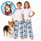 Two children wearing matching white t-shirts and blue patterned pajama pants with cartoon dog illustrations, standing barefoot on a white studio background next to a corgi. A circular inset shows a cartoon dog wearing a red scarf.