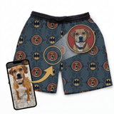 Pajama shorts with dog pattern and Batman logo, paired with a phone showing a dog photo.