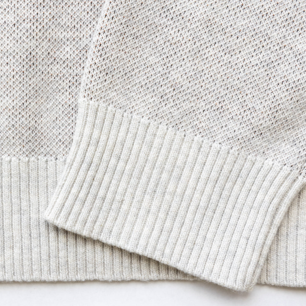 Close up of sleeves of the knit sweater.