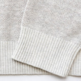 Close up of sleeves of the knit sweater.