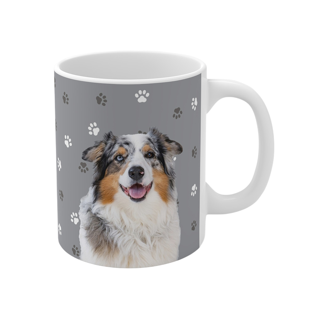 Gray ceramic mug with paws pattern, featuring a smiling, multicolored Australian Shepherd