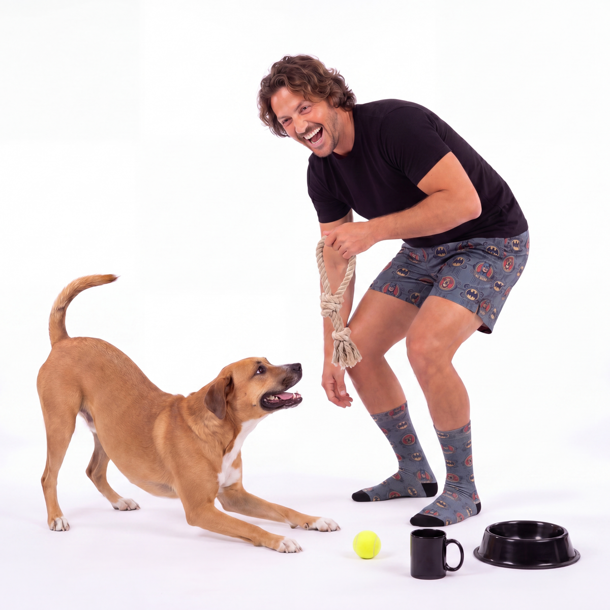 Man playing with a dog on a white background