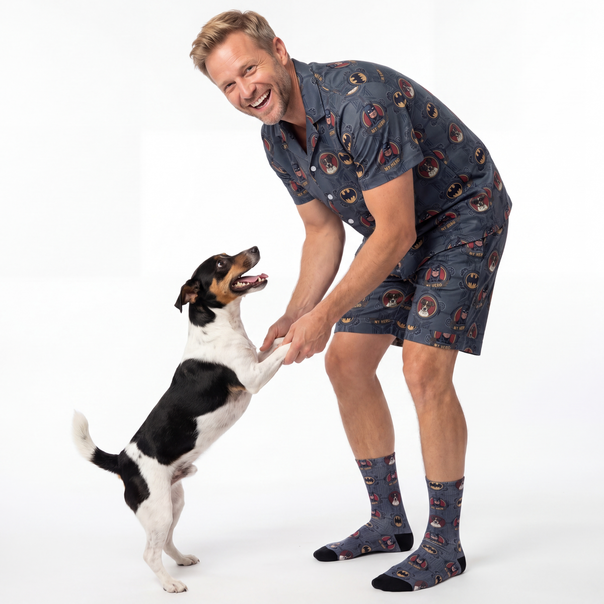 Man and dog wearing matching pajama sets on a white background
