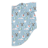 A light blue baby blanket with a repeating pattern of Dalmatian dogs, snowmen, Christmas trees, and snow-capped houses, shown on a plain white background.