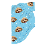 Light blue dog pajama with repeating pet faces on them