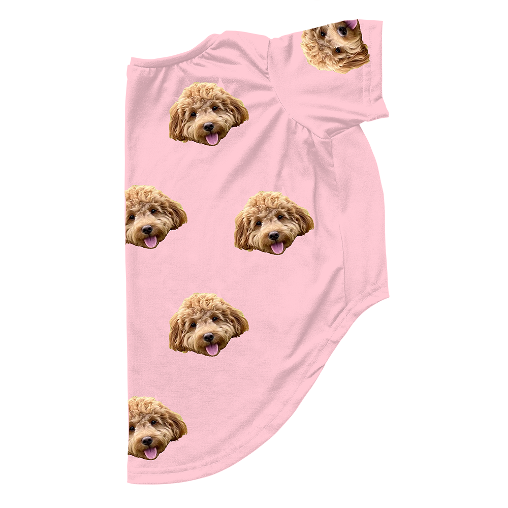 Pink dog pajama with repeating pet faces on them