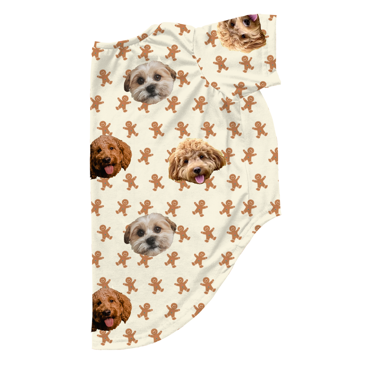A piece of custom dog pajamas, cropped at the bottom and right side, featuring an off-white or cream background. The pattern includes small, repeating brown gingerbread men. The pattern is customized with multiple repeating images of three different dogs' faces.