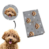 Gray wrapping paper with paws covering a box 