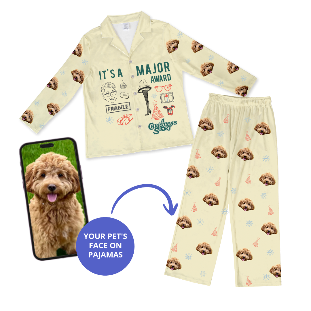 Cream-colored children's pajama set featuring a repeating dog's face pattern and various cartoon designs including the leg lamp and the phrase 'It's a major award' from 'A Christmas Story', shown next to a smartphone displaying a dog's photo with a bubble that reads 'Your pet's face on pajamas'.
