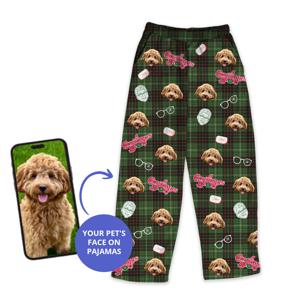 Green plaid pajama pants featuring a dog's face pattern with glasses and Christmas-themed icons and the phrase 'Cotton Headed Ninny Muggins', shown next to a smartphone displaying the dog's photo.
