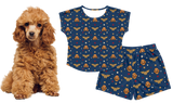 Dog wearing a Wonder Woman-themed outfit with a matching shirt and shorts on a white background