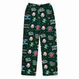 A pair of dark green Christmas-themed lounge pants featuring a repeating pattern of Dalmatian dogs in Santa hats, holiday text, and festive icons, shown flat against a white background.