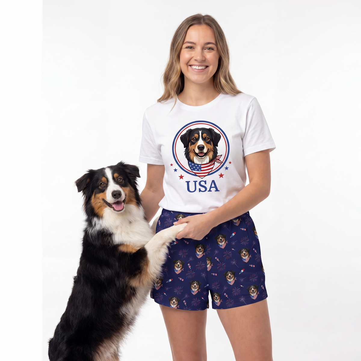 Woman wearing a white t-shirt with a dog graphic and 'USA' text, standing next to a dog on a white background.