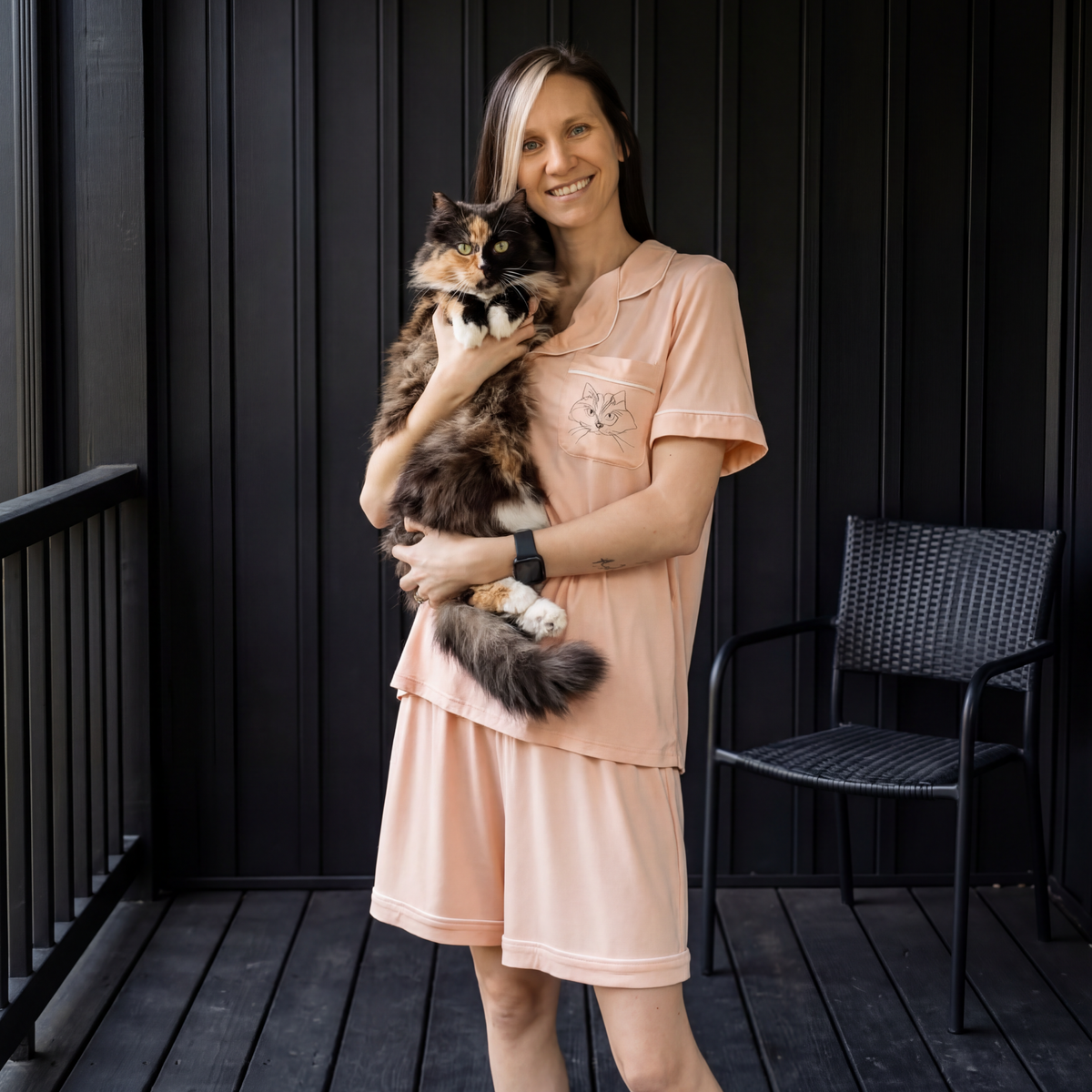 Woman wearing bamboo pajamas is holding a cat