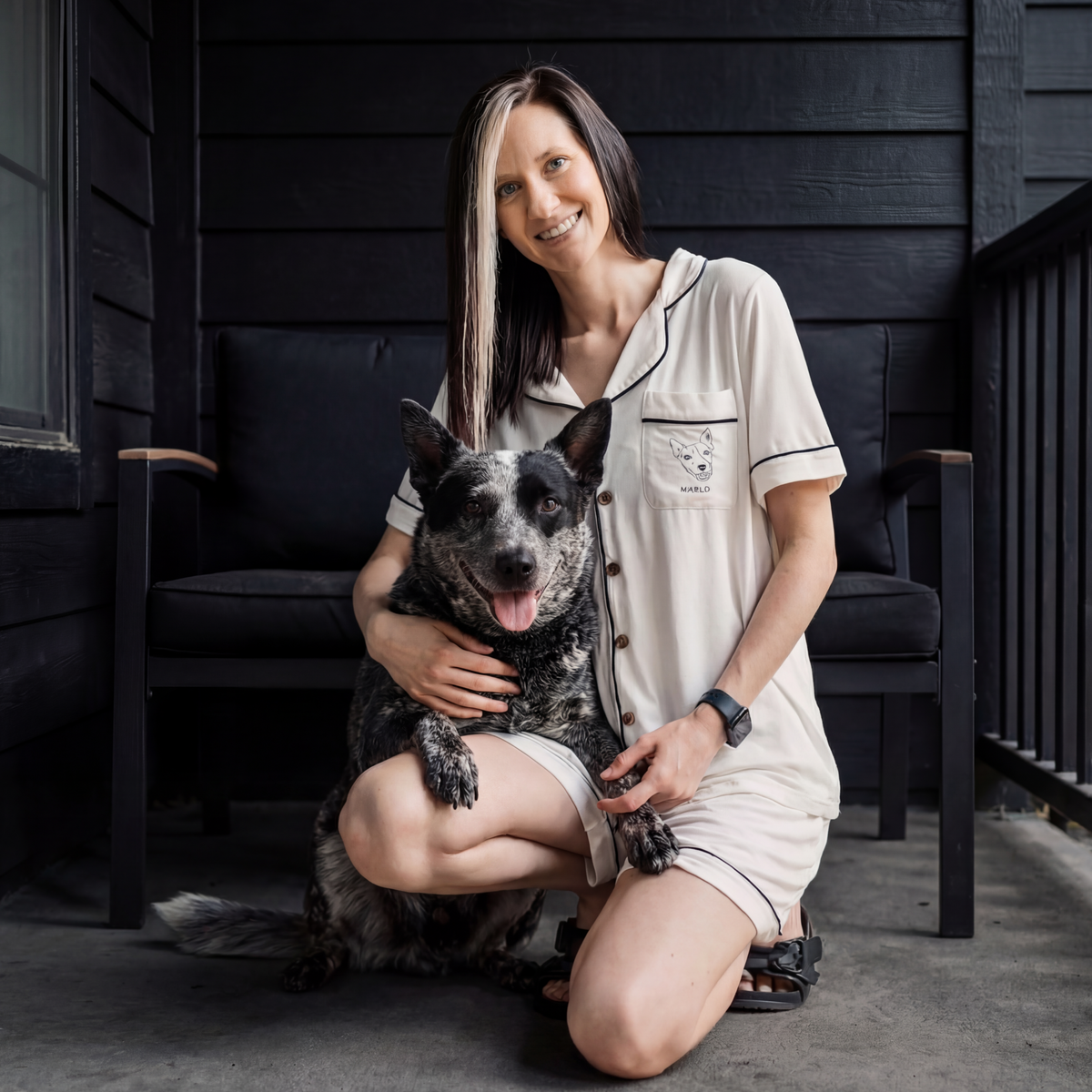 Woman wearing a white bamboo pajama with a dog