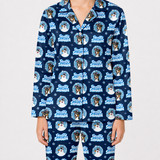 A person wearing a matching navy blue pajama set with a repeating 'Frosty Snowman' dog print, shown against a plain light gray studio background.