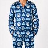 A man wearing a matching navy blue pajama set with a repeating 'Frosty Snowman' dog print, shown against a plain light gray studio background.