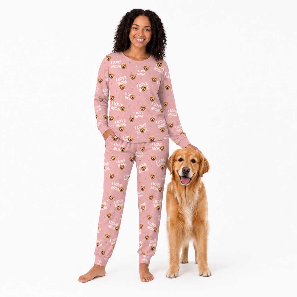 Woman wearing pink jogger pajamas with a dog on a white background