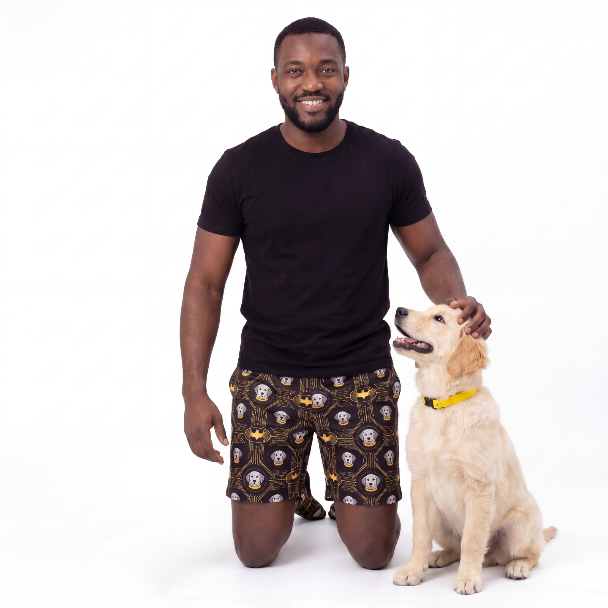 Man wearing batman shorts with a dog on a white background