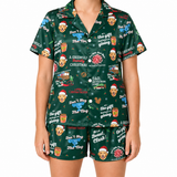 A model wearing a matching short-sleeve button-up pajama shirt and shorts set in dark green with a festive Christmas dog-themed print. The print features golden retriever dog portraits wearing Santa hats, holiday quotes like 'The Hoy is Christmas' and 'Dad, the gift is coming in the mail', a Santa train, and snowflakes.