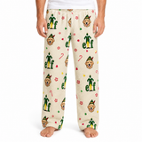 A person wearing cream-colored fleece pajama pants with a repeating pattern of Buddy the Elf character faces, green elf silhouettes, candy canes, and paw prints, shown against a plain white background.