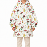 A child wearing a hooded pullover jacket with a festive Christmas print featuring dogs in Santa hats, holiday lights, pinecones, and the word 'Merry'. The jacket has a white base with red, green, and gold accents, and is shown against a plain white background.