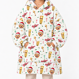 A person wearing a white hooded sweatshirt covered in a festive Christmas print featuring golden retriever dogs in Santa hats, gold platters, and red and green holiday accents, photographed against a plain white background.