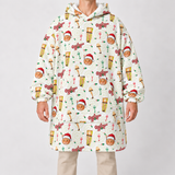 A person wearing a hooded sweatshirt with an all-over Christmas-themed print featuring ornaments, stockings, and 'Merry Christmas' text, paired with light beige pants, against a light gray studio background.