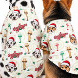 Two dogs wearing matching Christmas-themed dog shirts with a repeating print of the 'A Christmas Story' movie logo, lamp posts, holly, and dog faces on an off-white background.