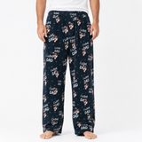 Black pajama pants with 'I Love Dad' print worn by a person on a white background