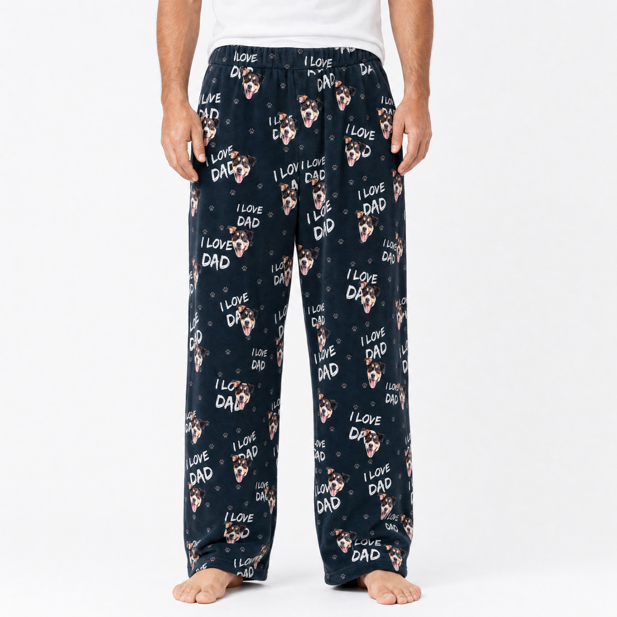 Black pajama pants with 'I Love Dad' print worn by a person on a white background