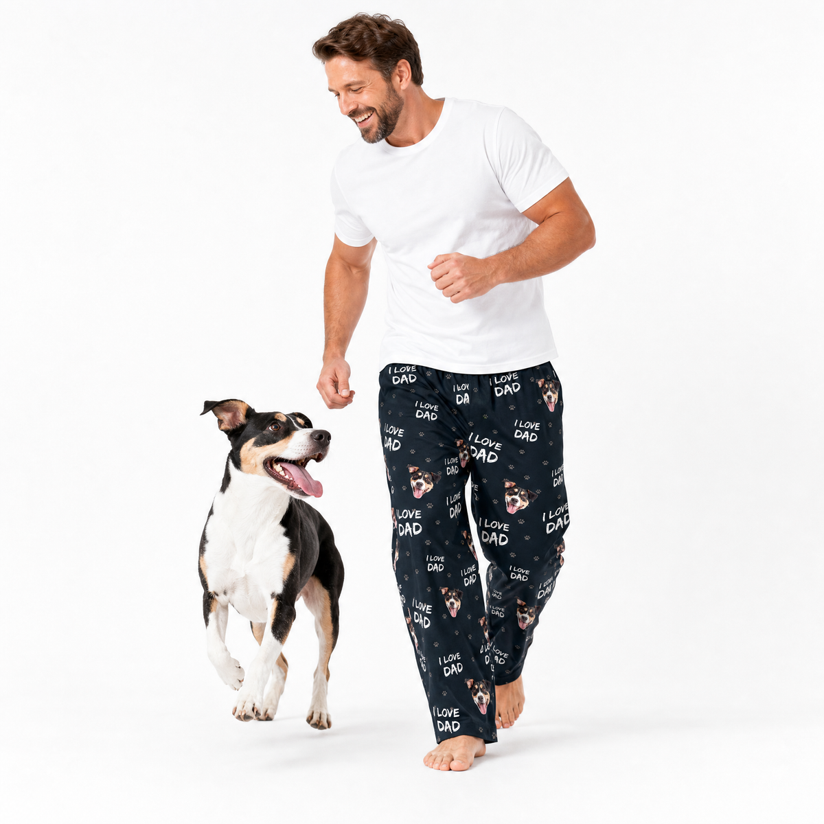 I love dad theme – person in dog-print pajamas walking with black, white, and tan dog.