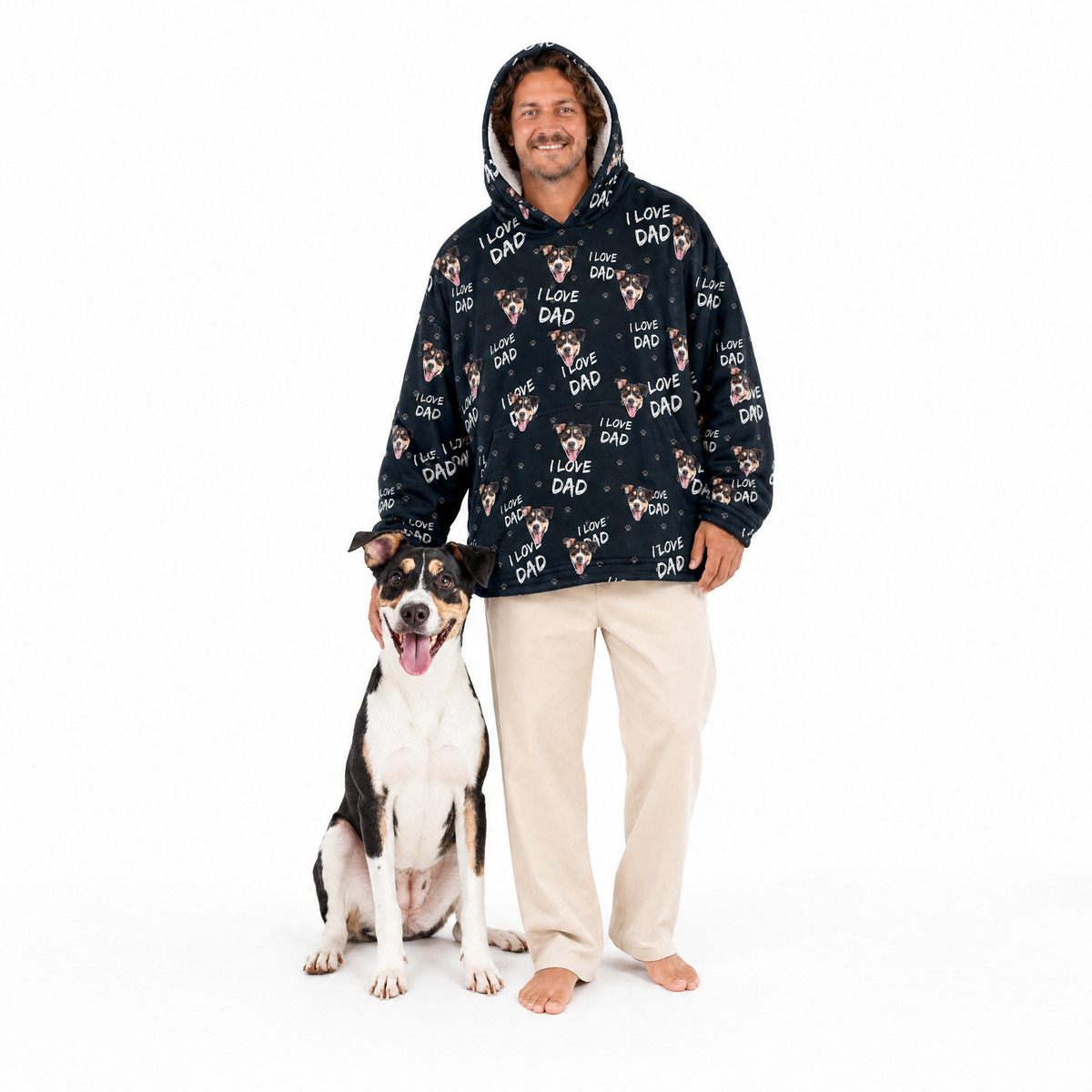 Man wearing a black blanket hoodie with 'I love dad' print standing next to a dog on a white background