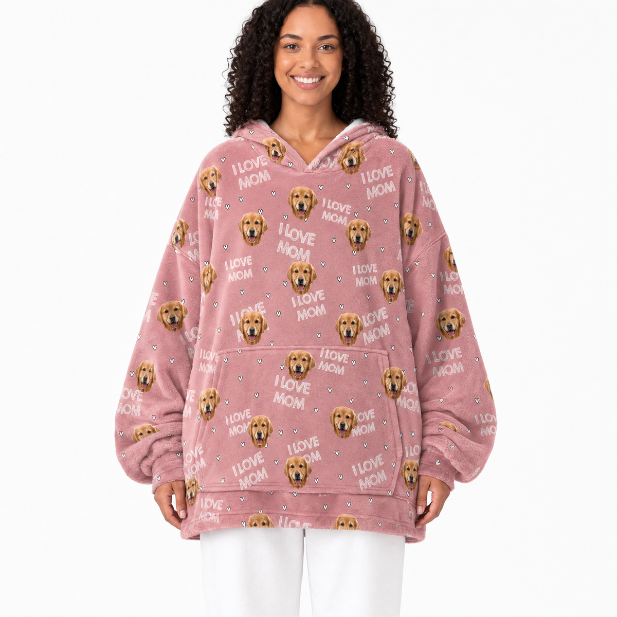 Woman wearing a pink blanket hoodie with dog graphics and 'I love mom' text on a white background
