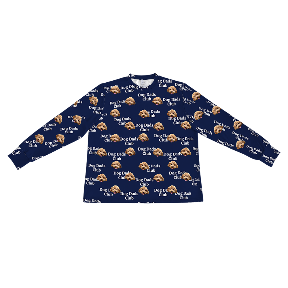 A navy blue long-sleeve pajama top with a crew neck. It features a repeating custom pattern of a light brown Goldendoodle's face, interspersed with the white text "Dog Dads Club" in a repeating diagonal pattern.