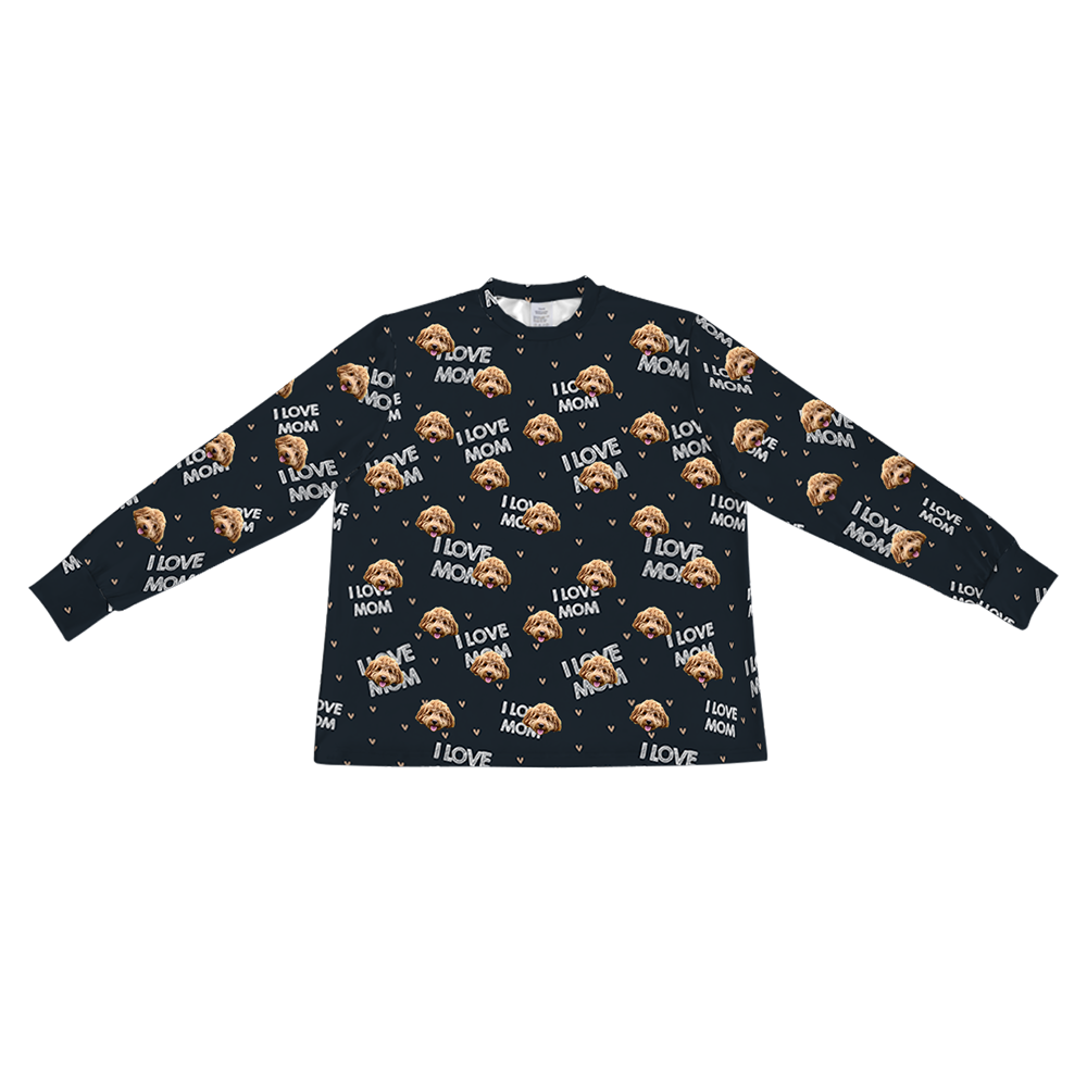 A black long-sleeve pajama top with a crew neck. It features a repeating custom pattern of a light brown Goldendoodle's face, interspersed with the white text "I LOVE MOM" and small tan V-shapes.
