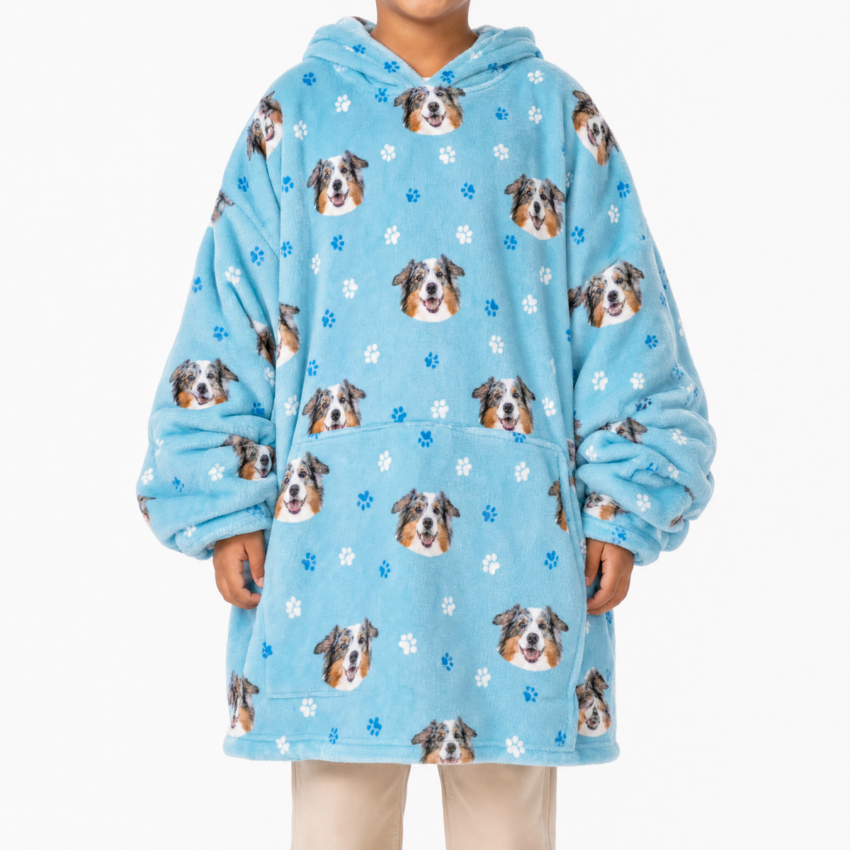 Light blue blanket hoodie with dog pattern worn by a child on a white background