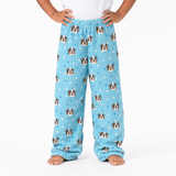 Light Blue pajama pants with dog pattern worn by a person on a white background