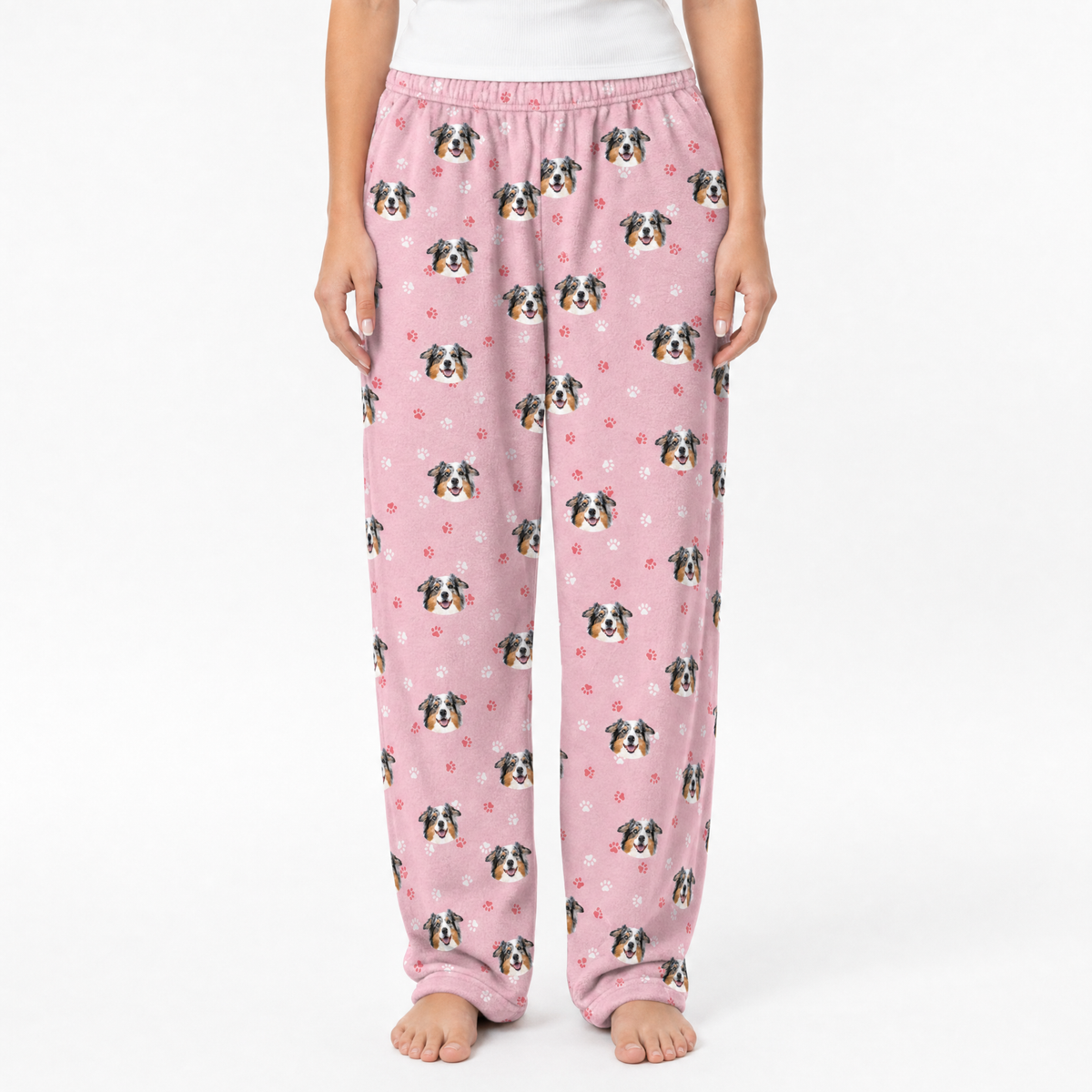Pink pajama pants with dog pattern on a white background