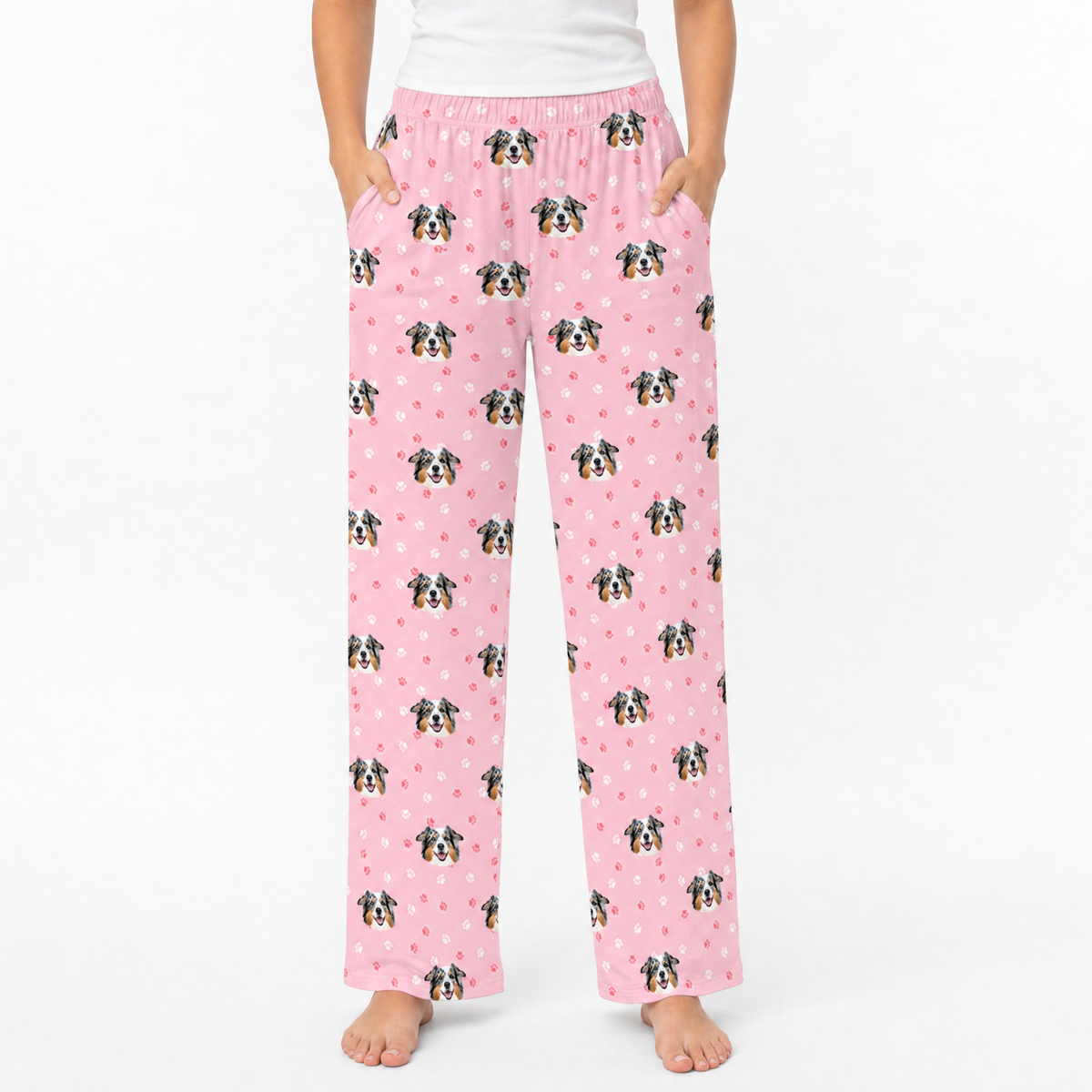 Pink pajama pants with a dog pattern on a white background