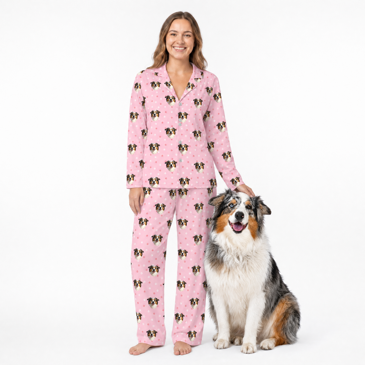 Woman in pink pajamas with a dog on a white background