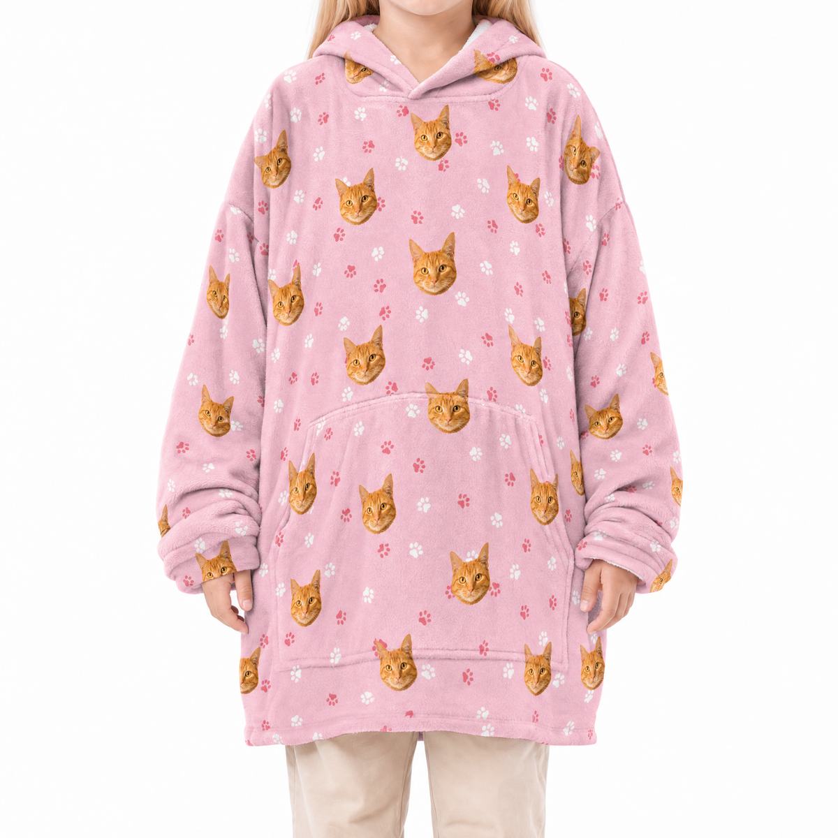 Pink blanket hoodie with cat pattern worn by a person on a white background