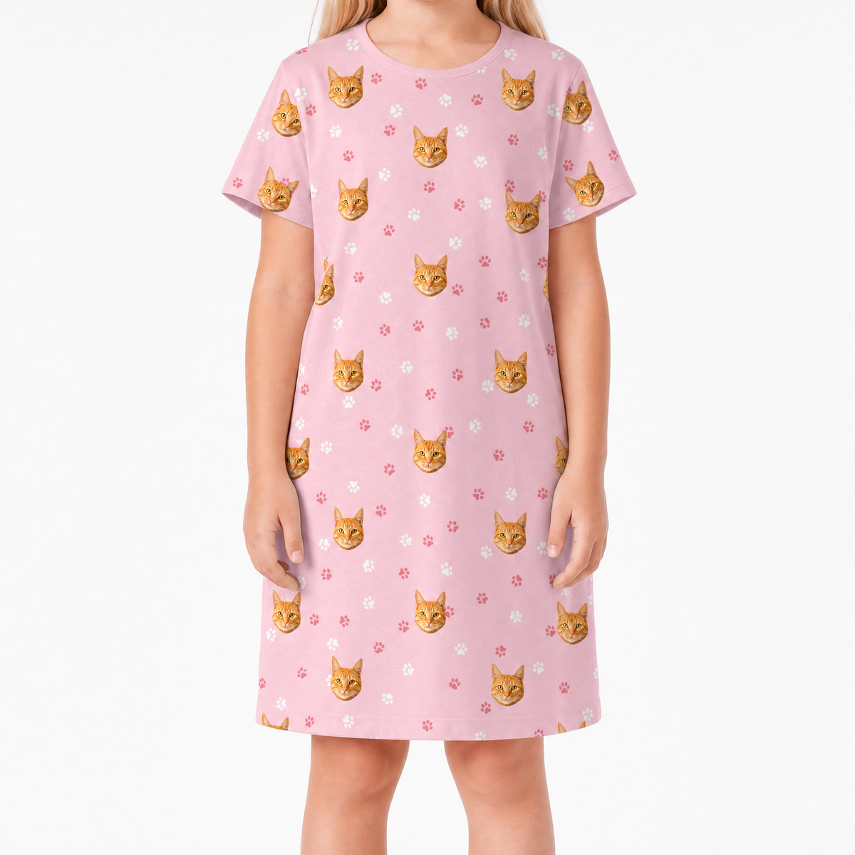 Pink nightgown with cat pattern worn by a person on a white background