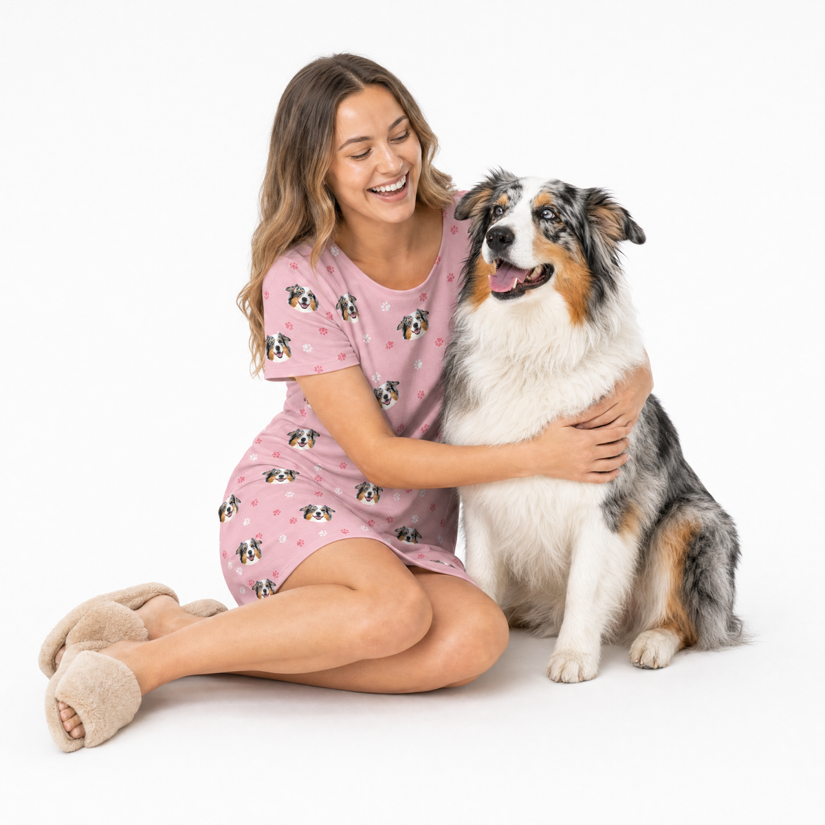 Woman in pink nightgown with a dog on a white background